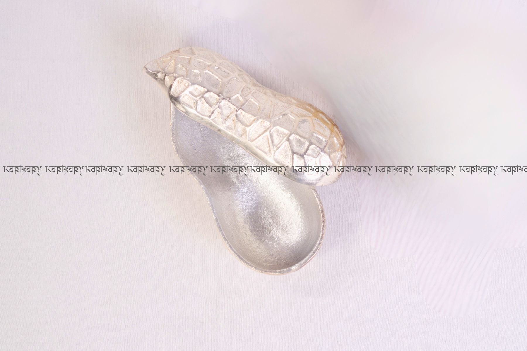 Decorative silver shell on a white background